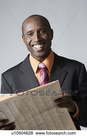 Businessman reading newspaper View Large Photo Image Stock Photo - Businessman reading newspaper. Fotosearch