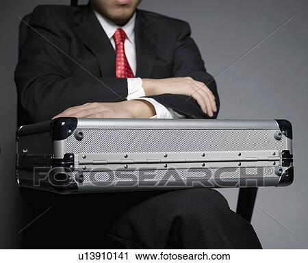 Businessman with Briefcase Sitting on Chair View Large Photo Image Stock Image - Businessman with Briefcase Sitting on Chair. Fotosearch