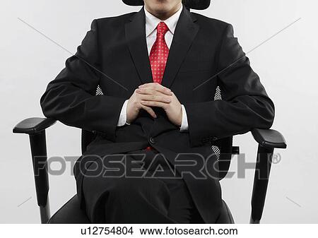 Businessman with Hands Clasped Sitting on Chair View Large Photo Image Picture - Businessman with Hands Clasped Sitting on Chair. Fotosearch