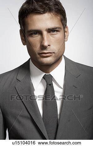 Stock Photograph - Portrait of mid adult man in suit. Fotosearch