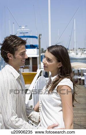 Young adult couple on pier, Side View, Differential Focus View Large Photo Image Stock Photography - Young adult couple on pier, Side View, Differential Focus. Fotosearch