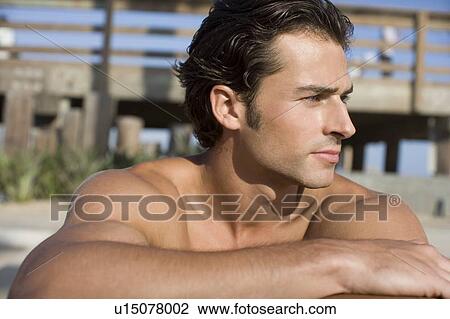 Young adult man on beach looking away, Front View, Differential Focus View Large Photo Image Stock Image - Young adult man on beach looking away, Front View, Differential Focus. Fotosearch