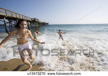 Young adult people having fun at beach, Front View View Large Photo Image Stock Image - Young adult people having fun at beach, Front View. Fotosearch