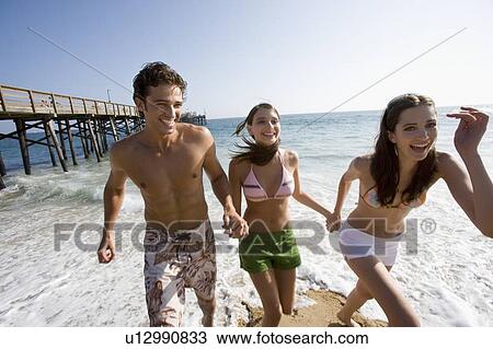 Young adult people having fun on beach, Front View View Large Photo Image Stock Image - Young adult people having fun on beach, Front View. Fotosearch