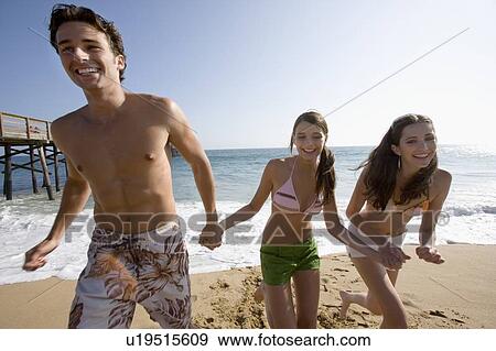 Young adult people having fun on beach, Front View View Large Photo Image Stock Photo - Young adult people having fun on beach, Front View. Fotosearch