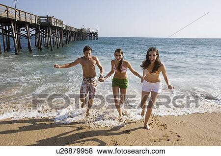 Young adult people having fun on beach, Front View View Large Photo Image Stock Photo - Young adult people having fun on beach, Front View. Fotosearch