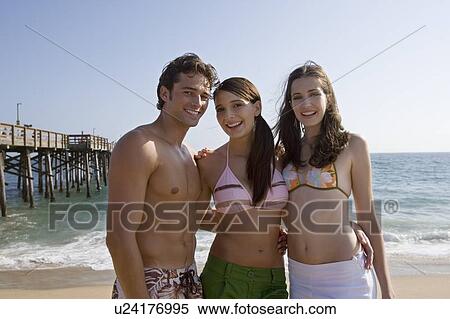 Young adult people smiling on beach, Front View View Large Photo Image Stock Photography - Young adult people smiling on beach, Front View. Fotosearch