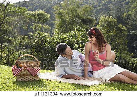 Picture - Young couple at picnic. Fotosearch
