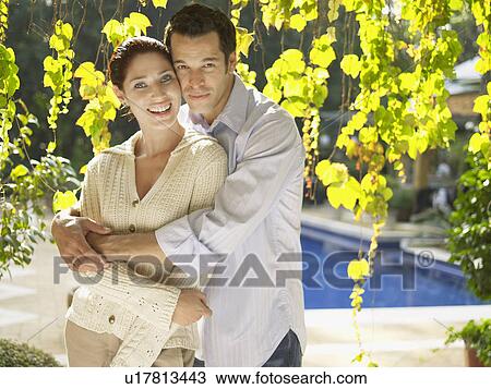 Young couple near swimming pool (portrait) View Large Photo Image Stock Image - Young couple near swimming pool (portrait). Fotosearch