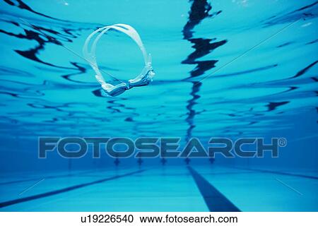 Stock Image - Swimming Goggles In Pool. Fotosearch