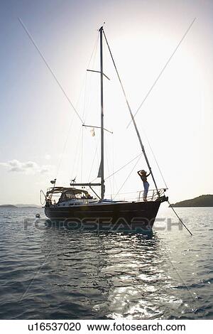 Stock Image - Woman on sailboat. Fotosearch