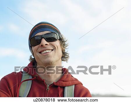 Stock Photo - Male hiker smiling, portrait. Fotosearch