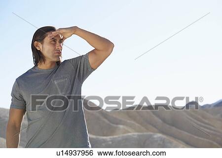Man looking at view in desert View Large Photo Image Stock Photograph - Man looking at view in desert. Fotosearch