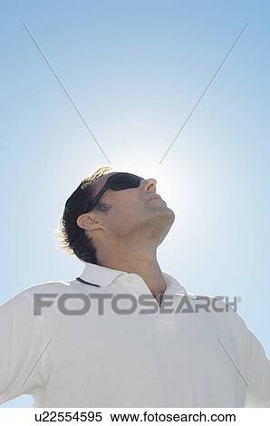 Mature man against clear sky (low angle view) View Large Photo Image Stock Photography - Mature man against clear sky (low angle view). Fotosearch