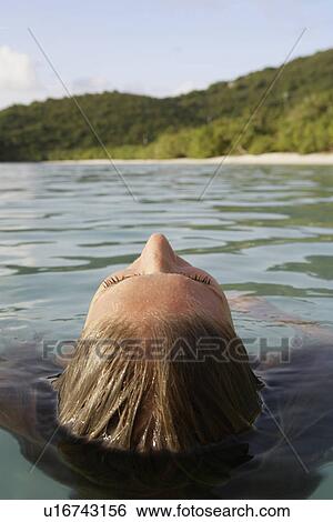 Mid adult woman swimming in ocean (rear view), St. John, US Virgin Islands, USA View Large Photo Image Stock Photograph - Mid adult woman swimming in ocean (rear view), St. John, US Virgin Islands, USA. Fotosearch
