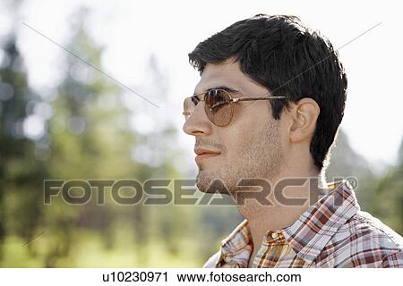 Portrait of young man with sunglasses View Large Photo Image Stock Image - Portrait of young man with sunglasses. Fotosearch