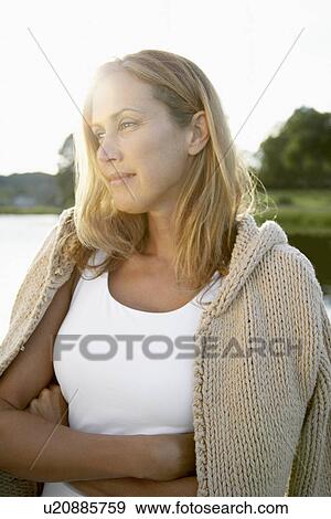 Woman looking into distance (lens flare) View Large Photo Image Stock Photo - Woman looking into distance (lens flare). Fotosearch