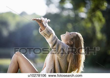 Woman with arms up to sky View Large Photo Image Stock Photograph - Woman with arms up to sky. Fotosearch