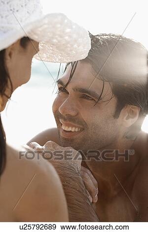 Young couple looking at each other View Large Photo Image Stock Photo - Young couple looking at each other. Fotosearch