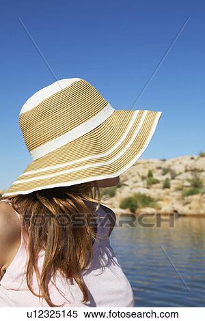 Young woman in sun hat looking at lake View Large Photo Image Stock Photography - Young woman in sun hat looking at lake. Fotosearch