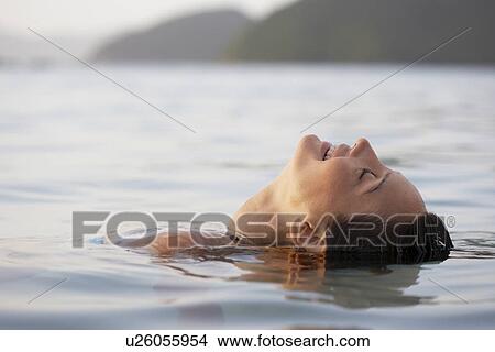 Young woman swimming View Large Photo Image Picture - Young woman swimming. Fotosearch