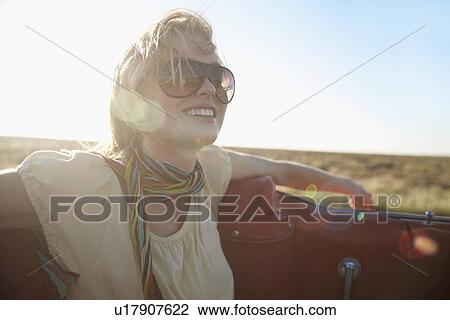 Young woman traveling in convertible View Large Photo Image Stock Image - Young woman traveling in convertible. Fotosearch