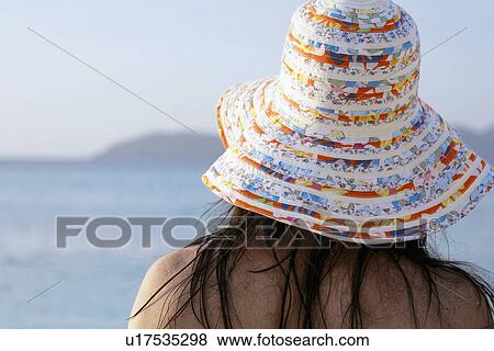 Young woman with hat looking at sea View Large Photo Image Stock Photo - Young woman with hat looking at sea. Fotosearch