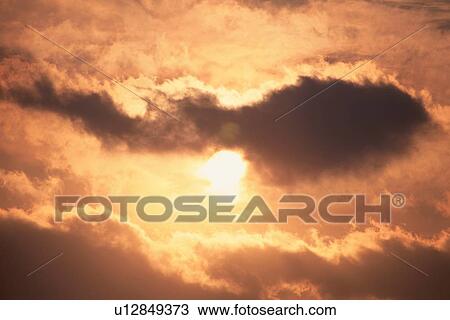 Stock Image - Sunrise Through Clouds. Fotosearch