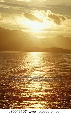 Stock Photo - Sunset Over Mountains And Sea. Fotosearch
