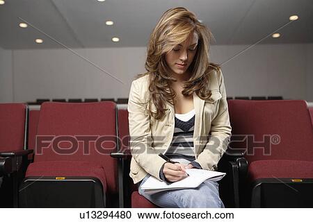Student making notes in lecture theater View Large Photo Image Stock Image - Student making notes in lecture theater. Fotosearch