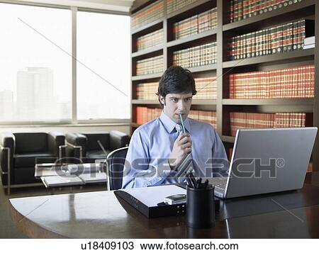 Businessman using laptop near bookcase View Large Photo Image Stock Image - Businessman using laptop near bookcase. Fotosearch