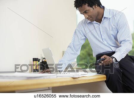 Businessman with PDA using laptop View Large Photo Image Stock Photography - Businessman with PDA using laptop. Fotosearch