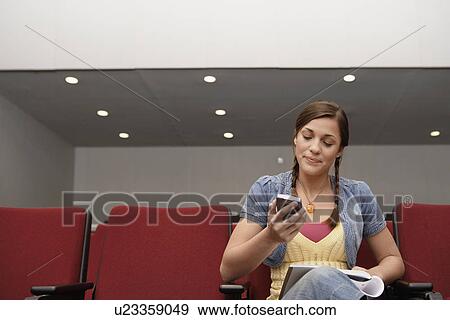 College student using PDA in lecture theater View Large Photo Image Stock Photo - College student using PDA in lecture theater. Fotosearch
