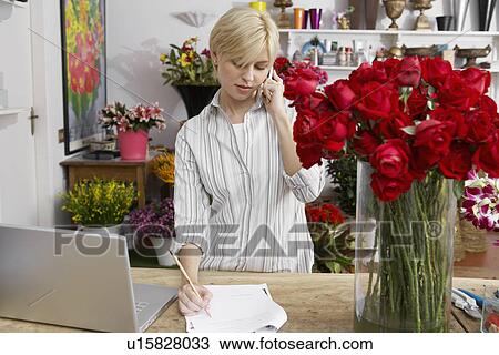 Female florist taking phone orders View Large Photo Image Stock Image - Female florist taking phone orders. Fotosearch