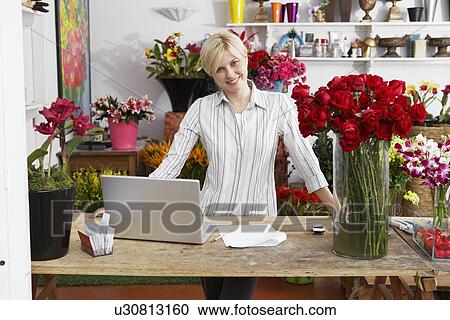 Female florist with laptop (portrait) View Large Photo Image Stock Image - Female florist with laptop (portrait). Fotosearch