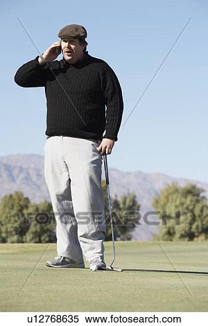 Man with golf club talking on phone View Large Photo Image Stock Photography - Man with golf club talking on phone. Fotosearch
