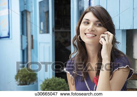 Young woman on cell phone View Large Photo Image Stock Photo - Young woman on cell phone. Fotosearch