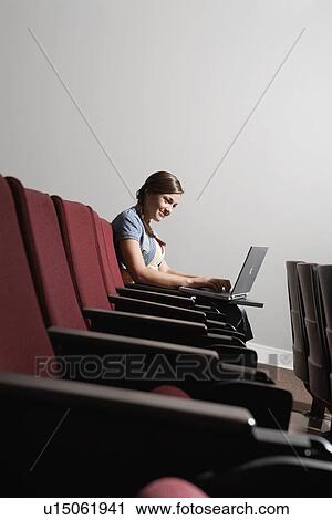 College student using laptop in lecture theater View Large Photo Image Stock Image - College student using laptop in lecture theater. Fotosearch