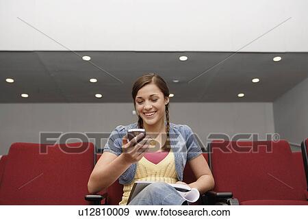 College student using PDA in lecture theater View Large Photo Image Stock Photo - College student using PDA in lecture theater. Fotosearch
