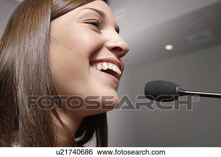 Stock Photograph - Student talking to microphone (close-up). Fotosearch