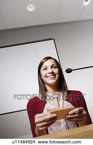 Student with paper notes giving presentation View Large Photo Image Picture - Student with paper notes giving presentation. Fotosearch