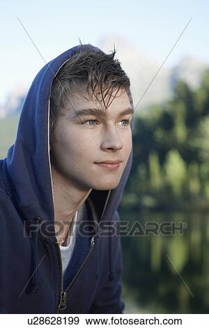 Teenage boy in hooded top View Large Photo Image Stock Photo - Teenage boy in hooded top. Fotosearch