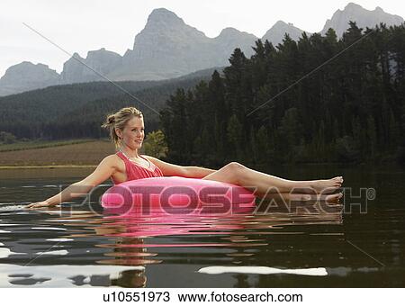 Teenage Girl on Inflatable Ring in Lake View Large Photo Image Stock Image - Teenage Girl on Inflatable Ring in Lake. Fotosearch
