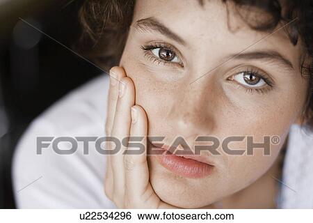 Teenage girl with chin on hand (portrait) View Large Photo Image Stock Photograph - Teenage girl with chin on hand (portrait). Fotosearch