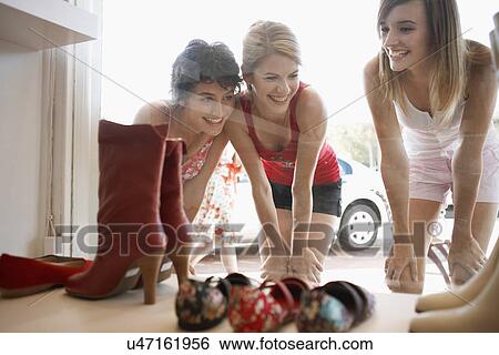 Teenage girls looking at shoes on window display View Large Photo Image Stock Photograph - Teenage girls looking at shoes on window display. Fotosearch