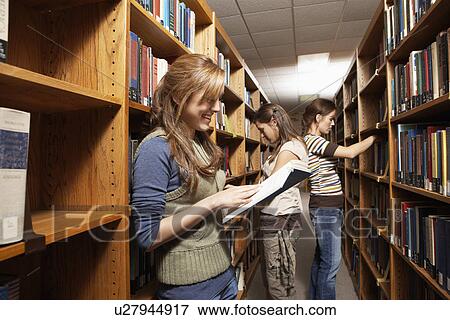 Stock Photo - Three female students in library. Fotosearch