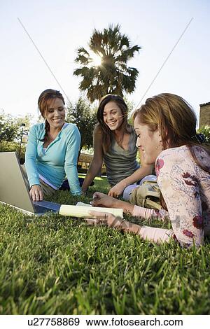 Three female students studying in park View Large Photo Image Stock Photo - Three female students studying in park. Fotosearch