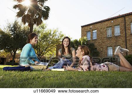 Stock Photo - Three female students studying near. Fotosearch