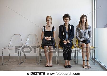 Three teenage girls sitting on chairs in lobby View Large Photo Image Stock Photograph - Three teenage girls sitting on chairs in lobby. Fotosearch
