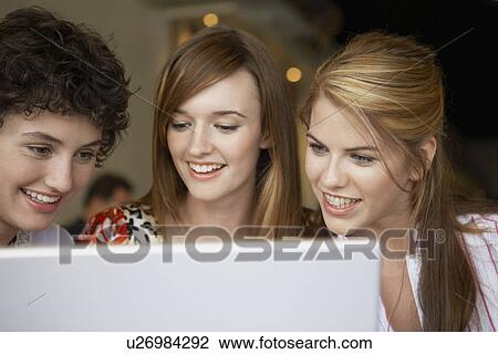 Three teenage girls using laptop View Large Photo Image Stock Image - Three teenage girls using laptop. Fotosearch